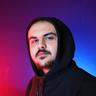 İsmail YAĞCI, Developer at Akinon, wearing a black hoodie against a blue and red background.